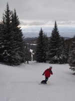 Snowboarder on Camp Robber trail at Ski Santa Fe